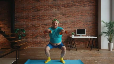 Fat man doing sport training with dumbbells at home Stock Footage 276891804