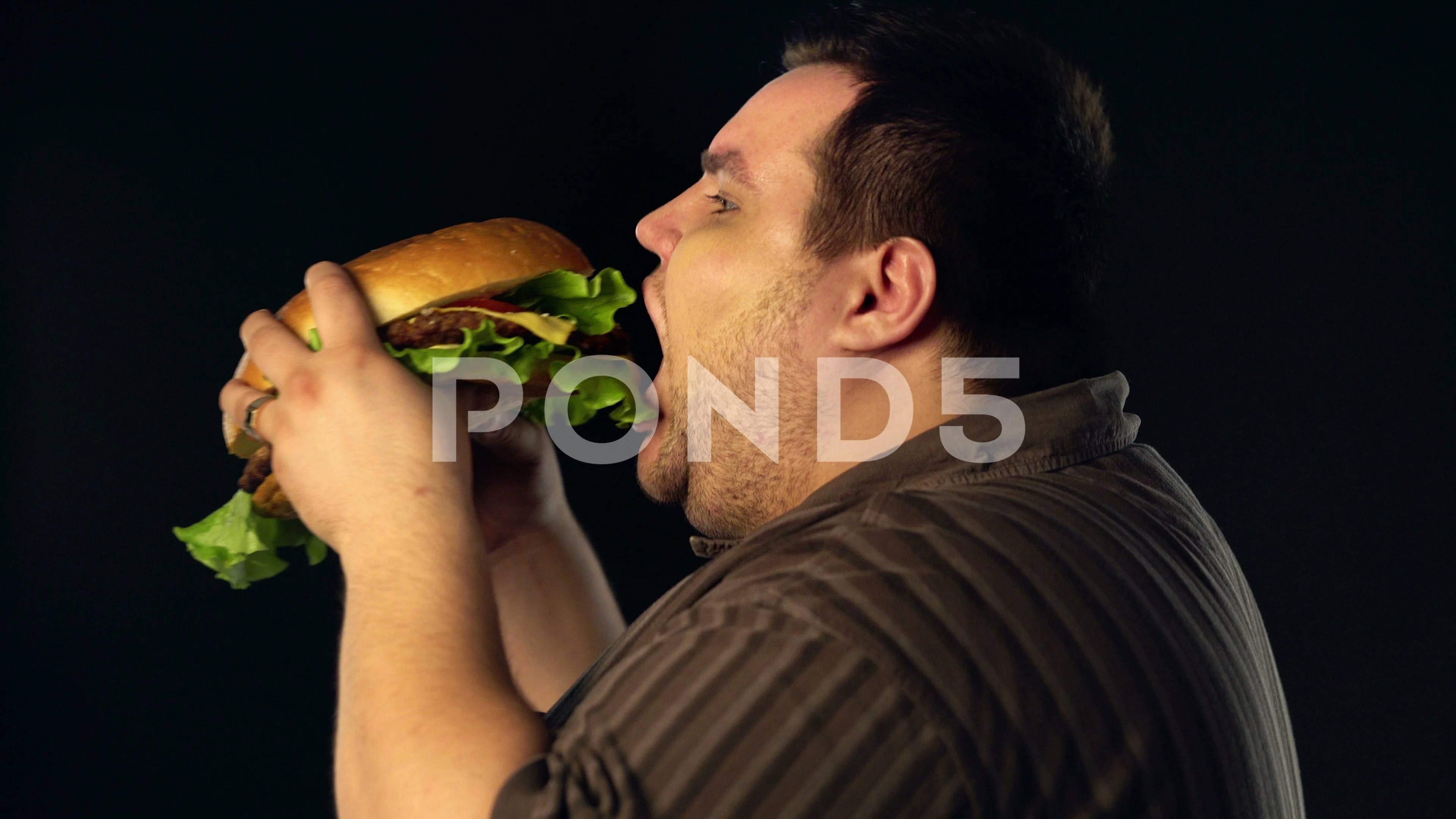fat person eating a burger