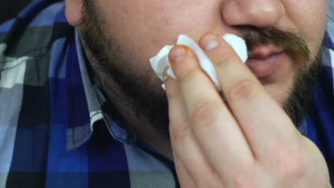 Fat man eats up the burger he made. Guy Wipes his mouth with a napkin. Unhealthy Stock Footage 112944945