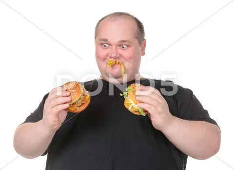 Fat man looks lustfully at a burger Stock Photos