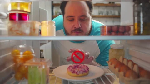 Fat man open fridge and look at donut with restriction hologram over it and take Stock Footage 220552644