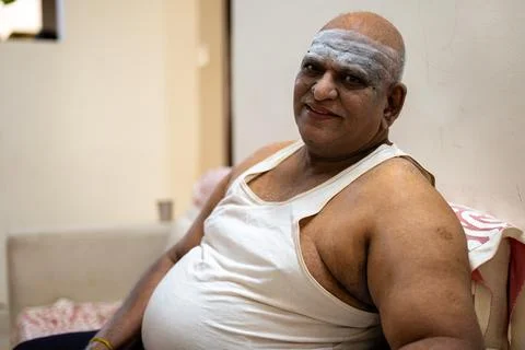 Fat Man Sitting on Sofa, Focused on Belly Stock Photo Stock Photos