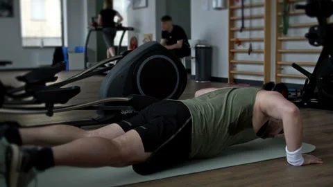 Fat man struggles to do plank exercise at the gym. Stock Footage 249802157