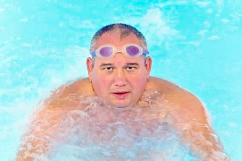 Fat man in the swimming pool Stock Photos