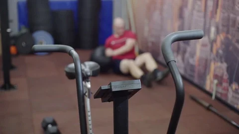 Fat man trains abs, does sit up Stock Footage 122853073