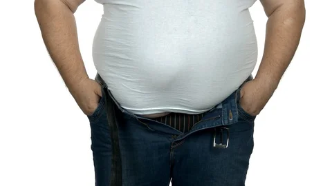 Fat man trying to fasten tight jeans., Stock Video