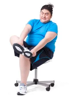 Fat man trying hard to put on sneakers Stock Photos