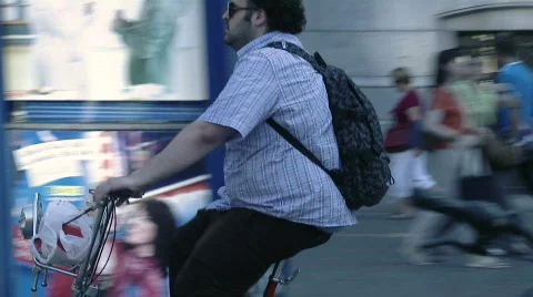 Fat men riding bicycle Stock Footage 567672
