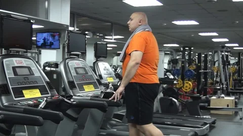 Fat walking on the treadmill Stock Footage 96553585