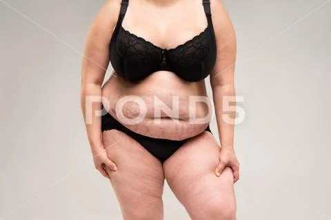 Plus size model in black lingerie, overweight female body, fat woman with  thick thighs isolated on white background Stock Photo
