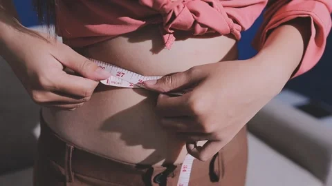 Fat woman, fat belly, chubby, obese woman hand holding excessive belly fat .. Stock Footage 336021189