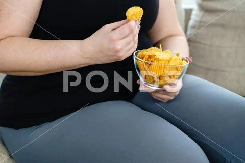 Fat woman overeating junk food. sedentariness Stock Photos