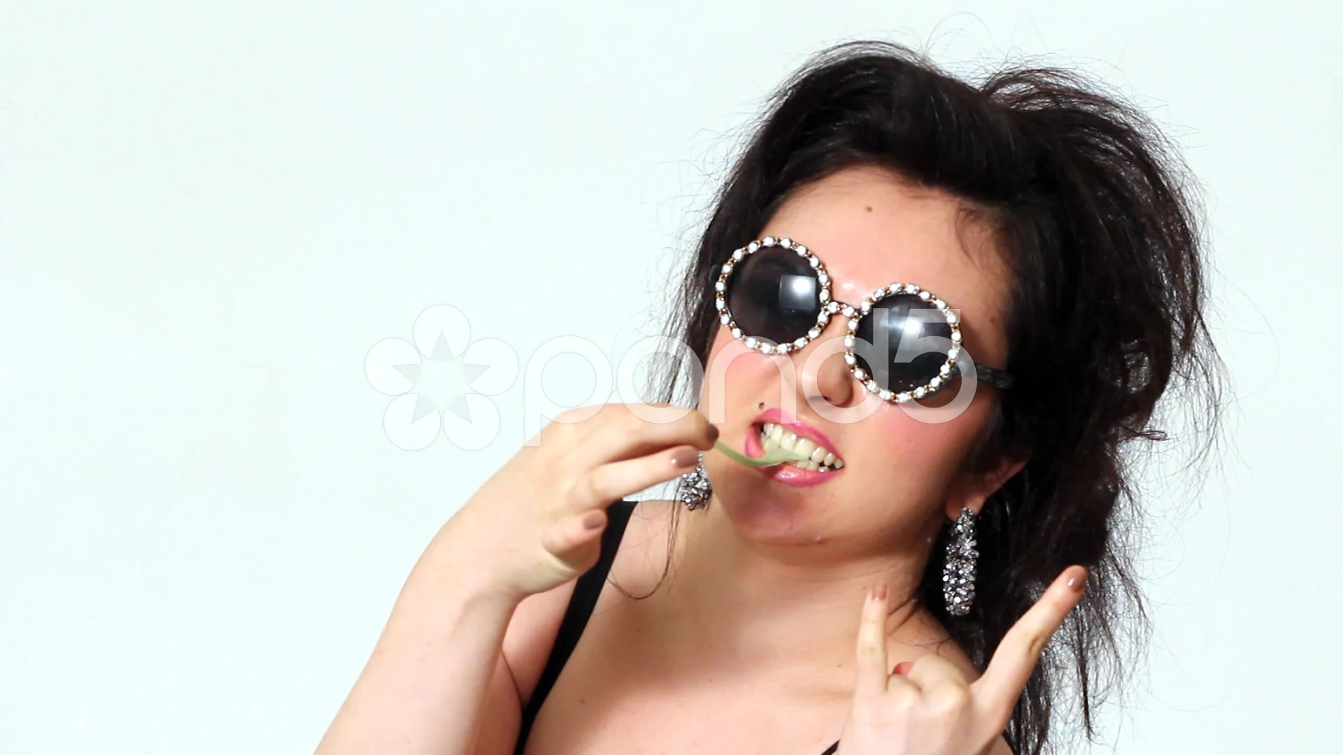 Fat woman posing in glasses with gum