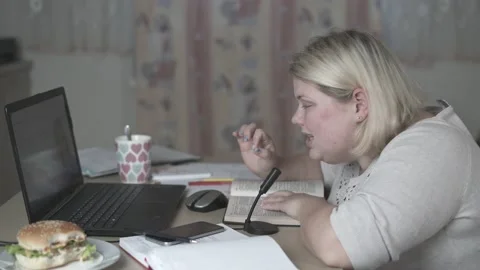 Fat woman studying foreign language online on laptop sitting at desk. Remote Stock Footage 144649701