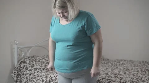 Severely Overweight Person Weighing Herself Himself Stock Footage Video  (100% Royalty-free) 1016930296