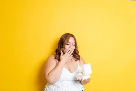 Fat young model opening gift box with surprise face at christmas Stock Photos