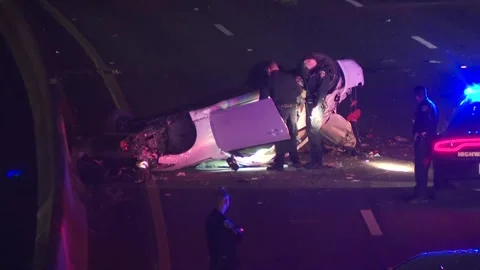 FATAL CAR CRASH FLIP OVER AT NIGHT ON FREEWAY Stock Footage 156840233