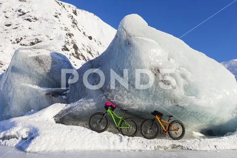 Fatbikes, 907 fat tire bike and Fatback fat tire bike, resting against giant ice Stock Photos