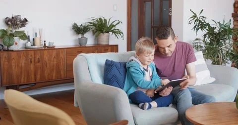 Father and child looking using tablet device Video stock 120333131