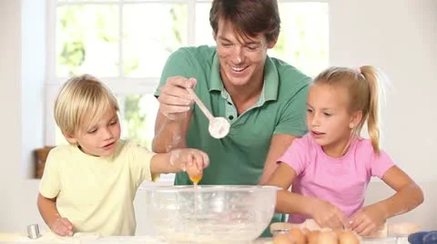 Father and children breaking eggs Stock Footage