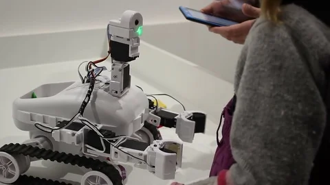 Father and children controls the robot with tablet Stock Footage 71890571