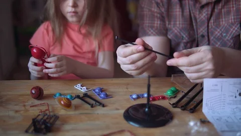 Father and cute child make a model of the solar system in the room. Stock Footage 104702196