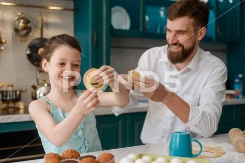 Father and daughter baking cookies in kitchen Stock Photos