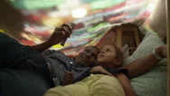 Father And Daughter In A Blanket Fort Playing With Some Flashlights. Stock Footage