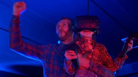 Father and daughter cheering while using augmented reality head set. Stock Footage 124364037