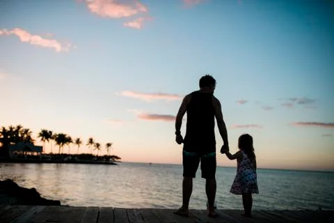 Father and daughter on a dock together Stock Photos