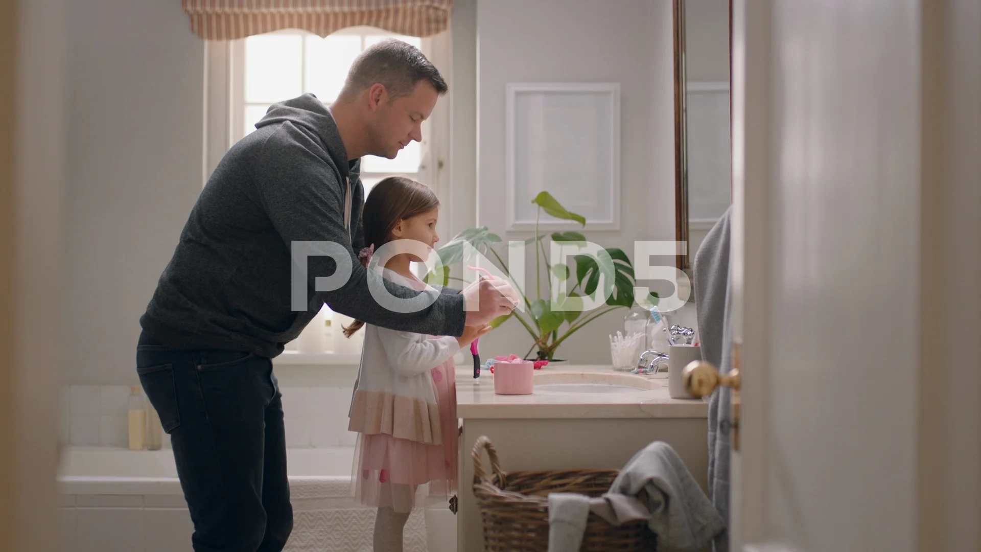 father and daughter having fun dad helping little girl get ready in bathroom