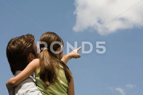 Father and daughter looking at cloud Stock Photos