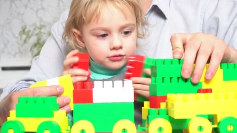 Father and daughter playing with constructor set Stock Footage 72115483