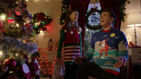 A father and daughter react with excitement after turning on the Christmas Video stock 323329680