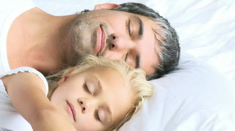 Father and daughter sleeping in a bed | Stock Video