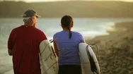 Father And Daughter Walk Along Beach. Stock Footage