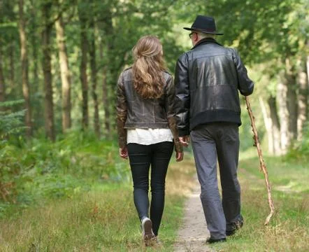 Father and daughter walking on path in the woods Foto stock