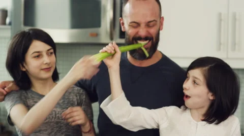 Father and daughters having fun together in kitchen Stock Footage 63860446