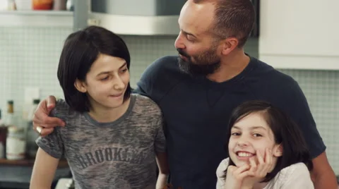 Father and daughters having fun together in kitchen Stock Footage 63860464