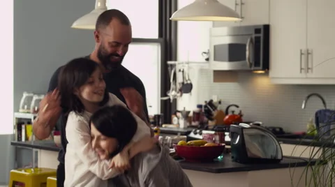Father and daughters having fun together in kitchen Stock Footage 63860869