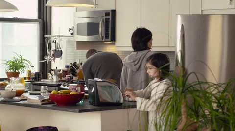 Father and daughters working in kitchen Stock Footage 63860952