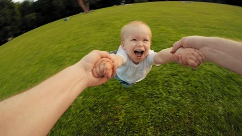 Father and happy smiling little son playing together on summer meadow POV shot Stock Footage 106525128
