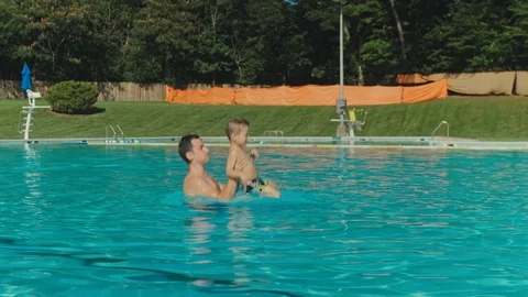 Father and his son having fun in the swimming pool. Happy, cute. Stock-Footage 123300436