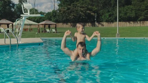 Father and his son having fun in the swimming pool. Happy, cute. Stock-Footage 123301545