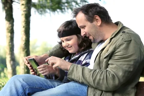 Father and his son with tablet computer outdoors NTSC Stock Footage 8540320