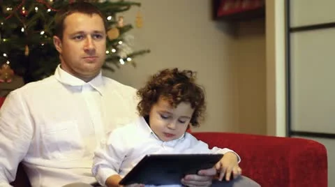 Father and his son with tablet computer pointing of something Stock Footage 11760053