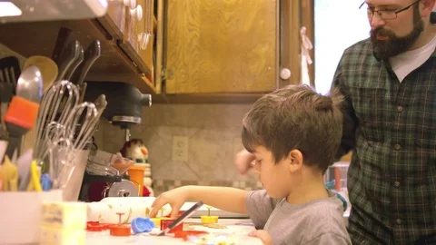 A father and his son using cookie cutters in the kitchen Vidéo 71041883