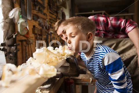 Father and little son with wood plank at workshop Stock Photos