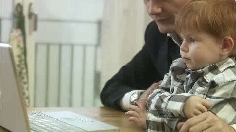 Father and small son using a laptop Video stock 11290938
