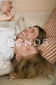 Father and son (8-9) laughing, portrait Stock Photos